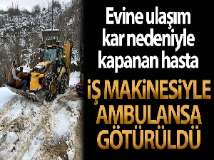 Kar nedeniyle yolu kapalı olan hasta iş makinesi ile ambulansa getirildi