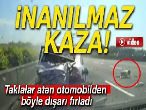 Taklalar atan otomobilden dışarı fırladı