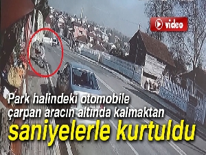 Park halindeki otomobile çarpan aracın altında kalmaktan saniyelerle kurtuldu