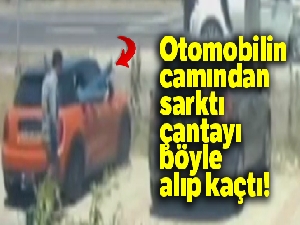 Otomobilin camından sarktı, çantayı böyle alıp kaçtı