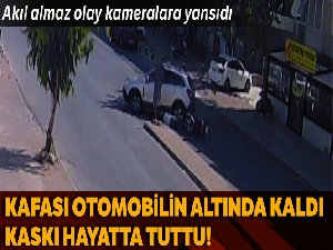 Kafası otomobilin altında kaldı, kaskı sayesinde kurtuldu