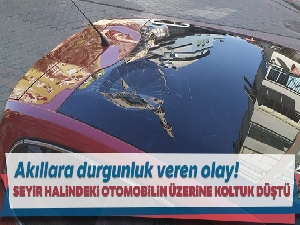 Seyir halindeki otomobilin üzerine 5'inci kattan atılan koltuk düştü