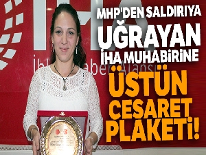 MHP'den saldırıya uğrayan İHA muhabirine üstün cesaret plaketi