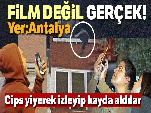 12 katlı apartmanın çatısından aşağı sarkan genç kadını film izler gibi izlediler