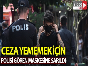 Polisi gören maskesine sarıldı