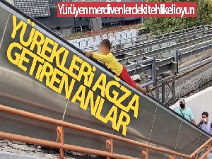 Küçük çocuğun yürüyen merdivenlerdeki tehlikeli oyunu kamerada