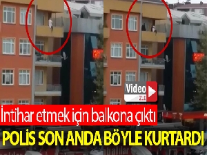 Polisin intihar etmek için balkona çıkan kadını kurtardığı anlar kamerada