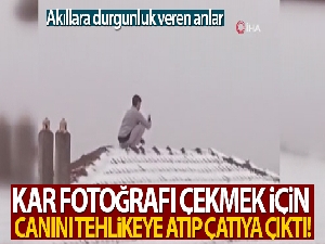 Kar fotoğrafı çekmek için canını tehlikeye atıp çatıya çıktı