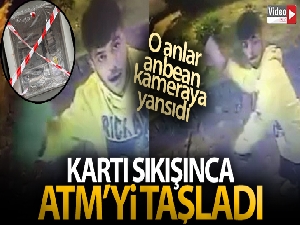 Kartı sıkışınca ATM'yi taşladı