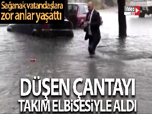 Düşen çantayı almak için takım elbisesiyle suya girdi