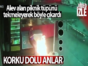 Alev alan piknik tüpünü tekmeleyerek böyle dışarıya çıkardı