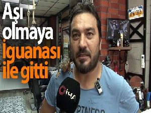 Aşı olmaya İguanası ile gitti