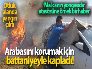 Yangına karşı ilginç yöntem: arabayı korumak için battaniyeyle kapladı