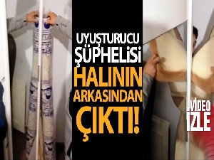 Uyuşturucu şüphelisi halının arkasından çıktı