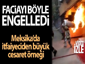 Faciayı engellemek için yanan tüp gazı sırtına alarak binadan çıkardı