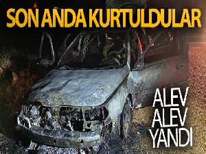 Alev alan araçtan son anda kurtuldular