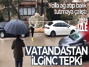 Göle dönen yollarda ağ atıp balık tutmaya çalıştı