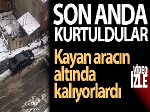 Buzlu yolda kayan aracın altında kalmaktan son anda kurtuldular
