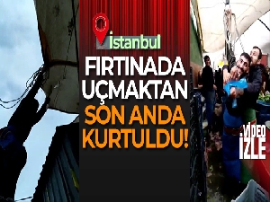 Fırtınada çadırını bağlarken uçma tehlikesi yaşayan pazarcı kamerada