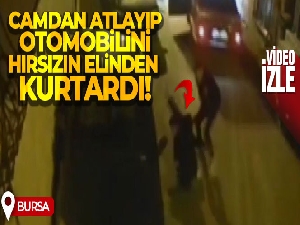 Camdan atlayıp otomobilini hırsızın elinden kurtardı