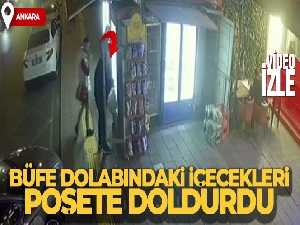 Büfe dolabındaki içecekleri poşetine dolduran hırsız kamerada