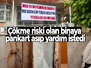 Bina çökmesin diye tahta parçalarıyla güçlendirme yapıp pankartla yardım istedi